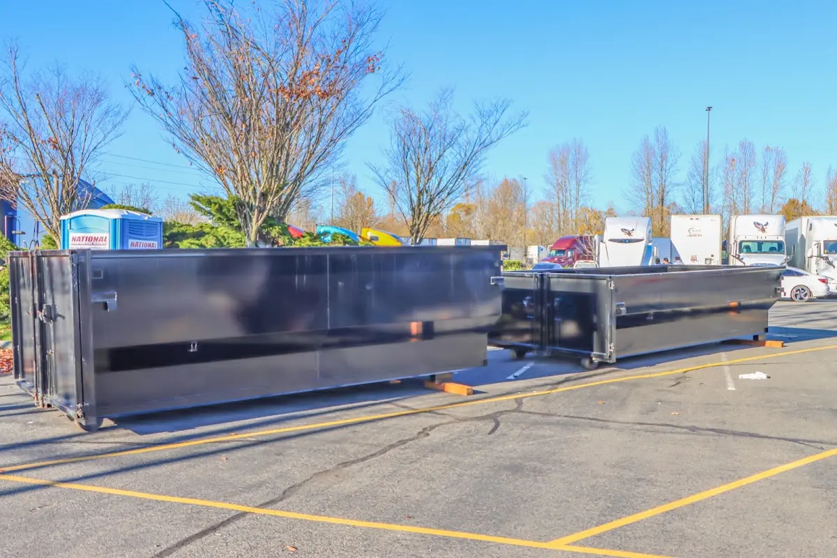 Professional dumpster rental service with roll-off container on residential driveway in North Highlands
